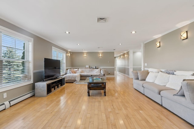 living room featuring baseboard heating, crown molding, and light hardwood / wood-style flooring