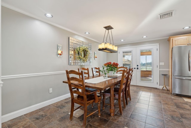 dining area with french doors and crown molding