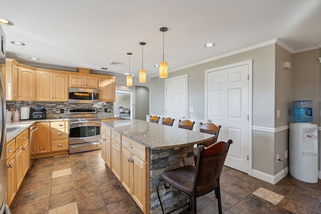 kitchen with appliances with stainless steel finishes, a center island, light brown cabinetry, and a kitchen bar