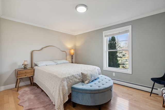 bedroom with light hardwood / wood-style flooring, ornamental molding, and baseboard heating