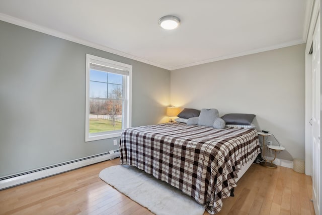 bedroom with a baseboard radiator, crown molding, and light hardwood / wood-style flooring