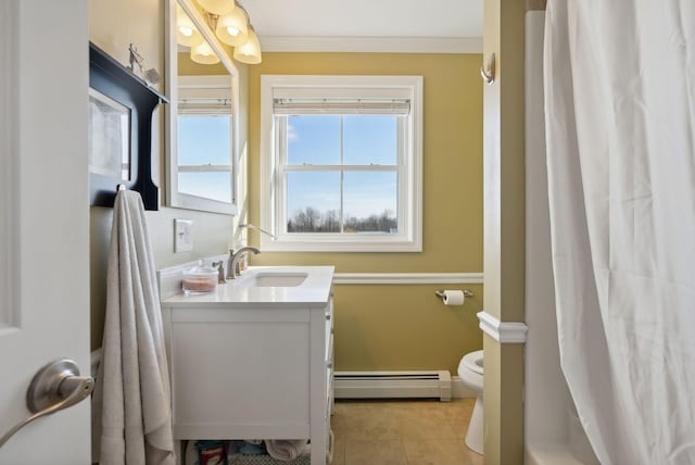 bathroom with tile patterned floors, toilet, baseboard heating, crown molding, and vanity