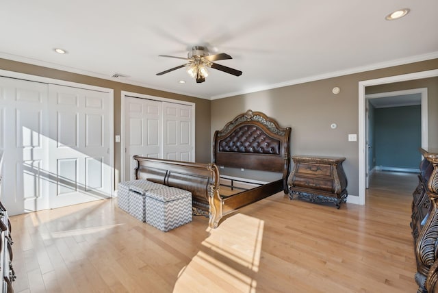 bedroom featuring crown molding, light wood-type flooring, and ceiling fan