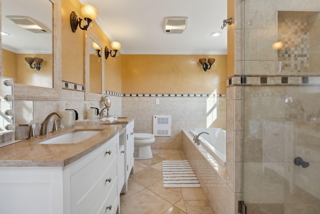 full bathroom with heating unit, tile walls, toilet, vanity, and tile patterned flooring