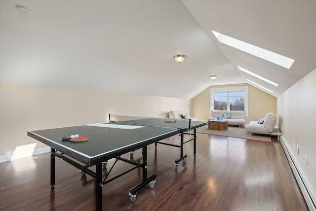 game room with lofted ceiling with skylight, baseboard heating, and wood-type flooring