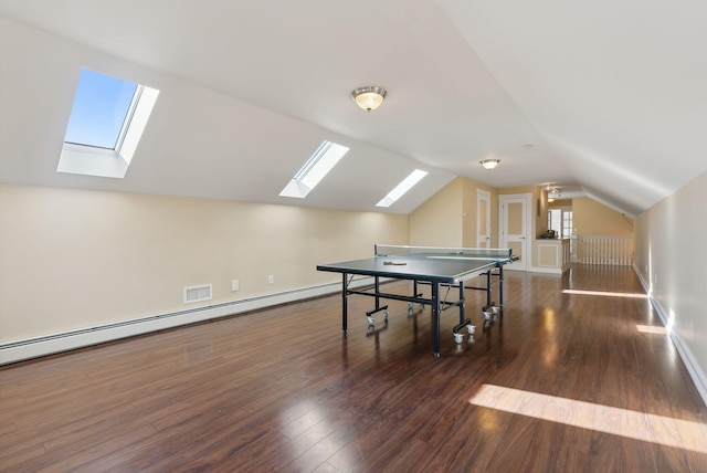 recreation room with vaulted ceiling, dark hardwood / wood-style flooring, and baseboard heating