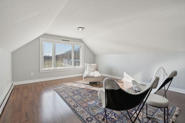 living area featuring baseboard heating, dark wood-type flooring, and vaulted ceiling