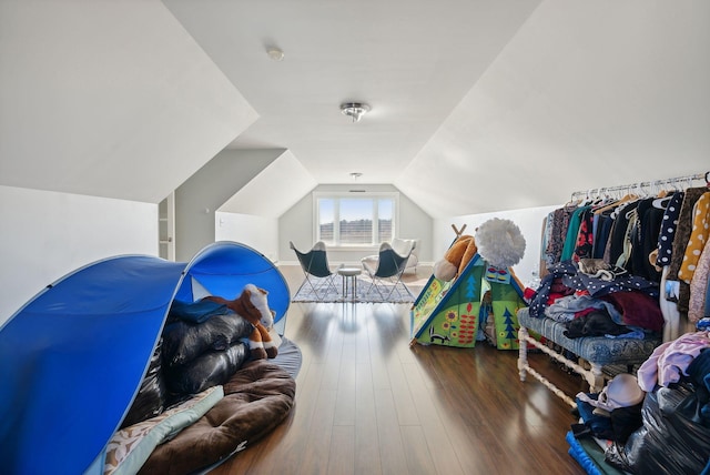 playroom with vaulted ceiling and dark hardwood / wood-style floors