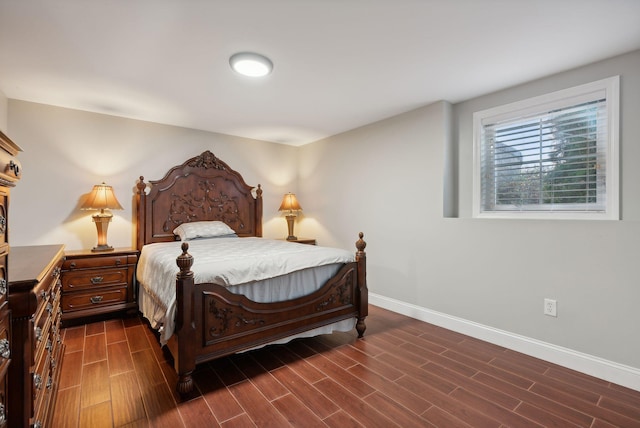 bedroom with dark wood-type flooring