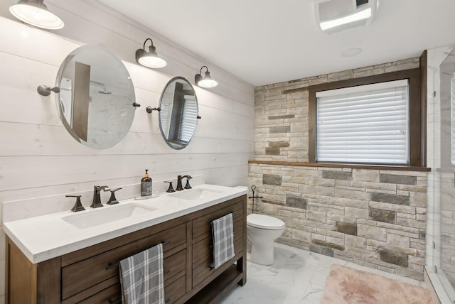 bathroom featuring vanity, toilet, a shower, and wooden walls