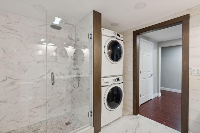 washroom with stacked washing maching and dryer