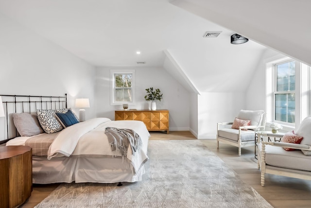 bedroom featuring vaulted ceiling and light hardwood / wood-style floors