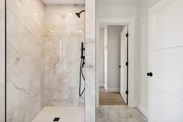 bathroom with tiled shower