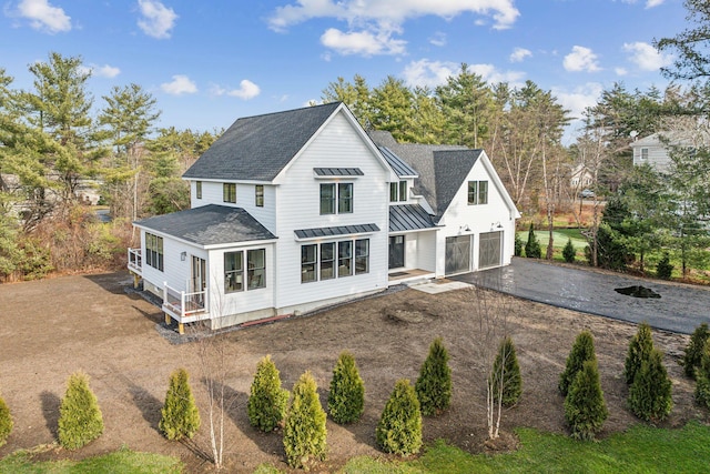 rear view of property featuring a garage