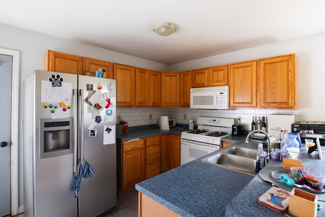 kitchen featuring sink, decorative backsplash, white appliances, and light tile patterned floors