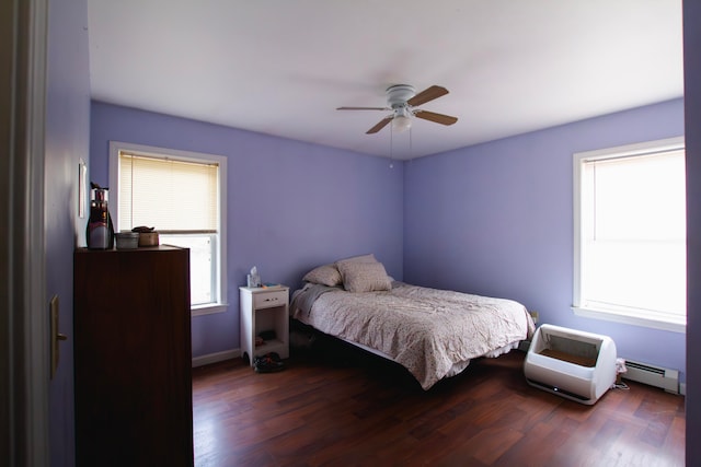 bedroom featuring baseboard heating, ceiling fan, and dark hardwood / wood-style flooring