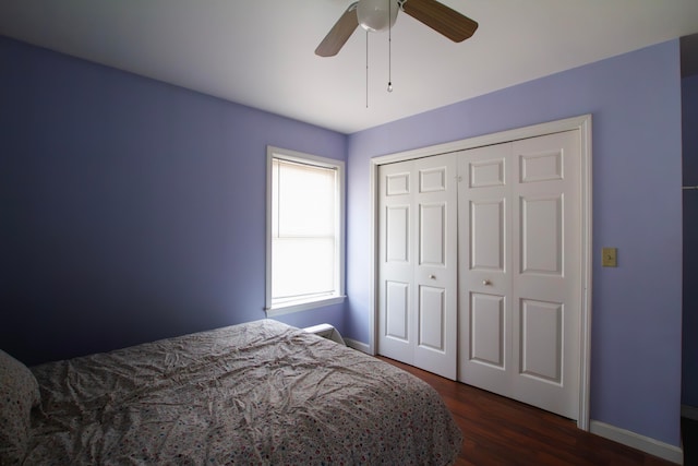 bedroom with a closet, ceiling fan, and dark hardwood / wood-style flooring