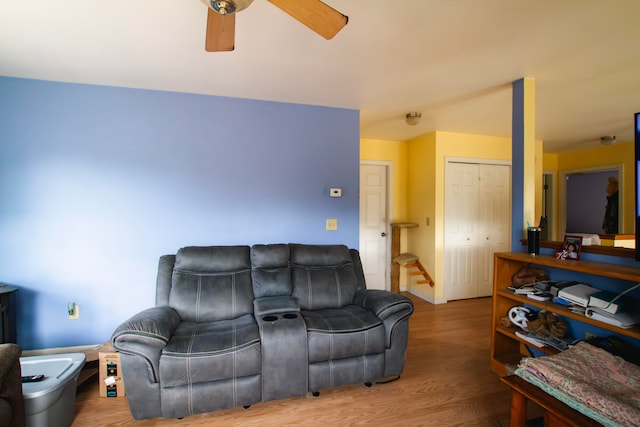 living room featuring hardwood / wood-style floors and ceiling fan