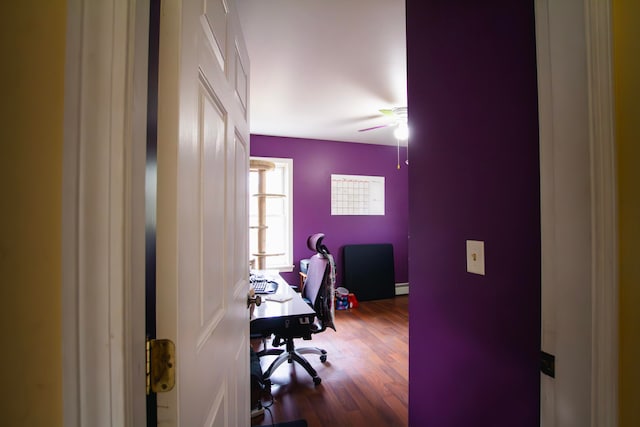 home office featuring hardwood / wood-style floors, baseboard heating, and ceiling fan