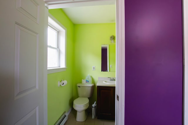 bathroom with toilet, baseboard heating, vanity, and tile patterned flooring