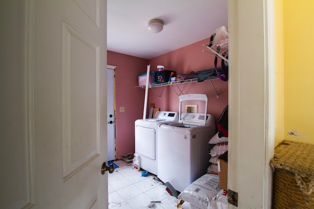 laundry room with washer and dryer and light tile patterned floors