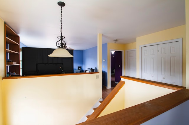 kitchen with kitchen peninsula, pendant lighting, and hardwood / wood-style floors