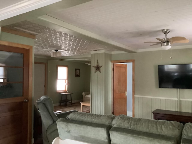 living room with crown molding and ceiling fan