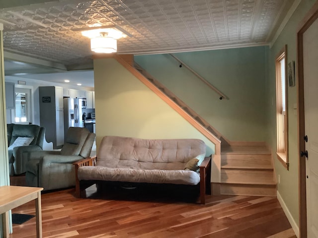 interior space with crown molding and wood-type flooring