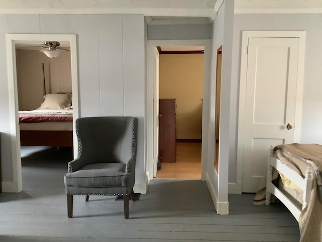 sitting room with wood-type flooring and ceiling fan