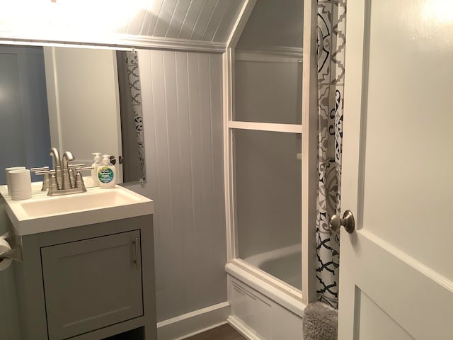 bathroom with vanity, shower / tub combo, ornamental molding, and wooden walls