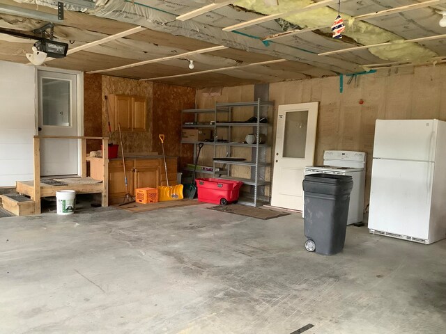 garage featuring a garage door opener and white refrigerator