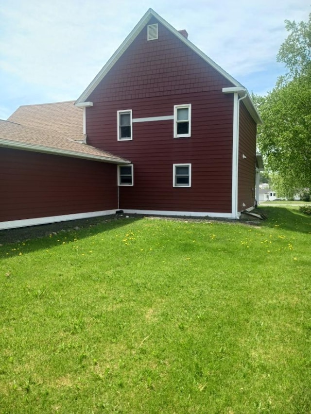 rear view of property with a lawn