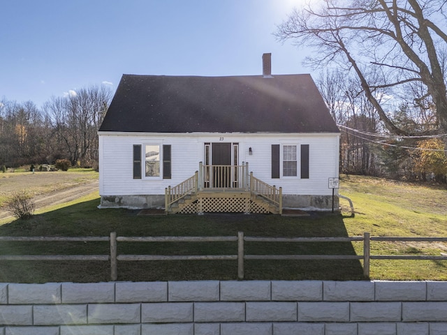 cape cod-style house with a front yard