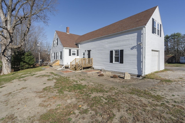 rear view of property with a garage