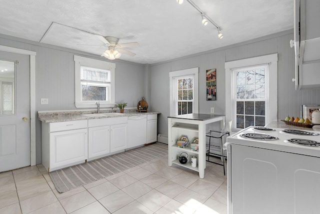 kitchen with sink, ceiling fan, light tile patterned floors, white appliances, and white cabinets