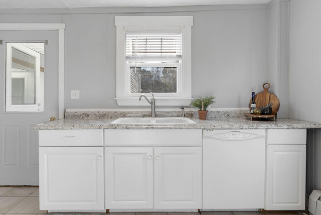 kitchen with white dishwasher, a baseboard radiator, sink, and white cabinetry