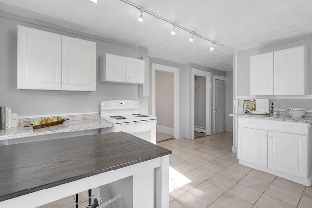 kitchen with light stone counters, white electric range oven, light tile patterned floors, baseboard heating, and white cabinetry