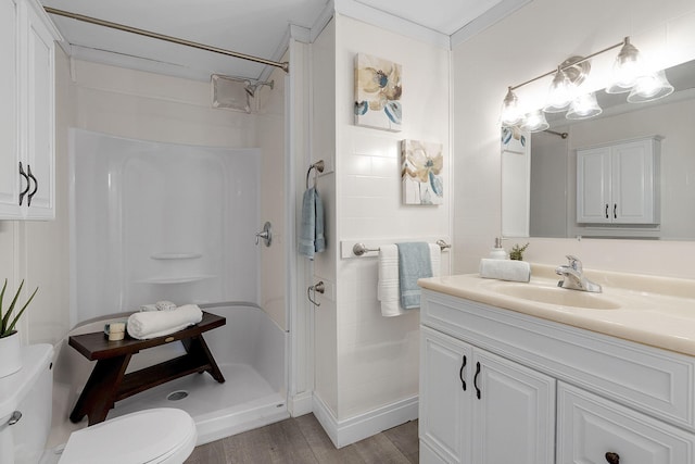 bathroom featuring walk in shower, hardwood / wood-style floors, vanity, and toilet