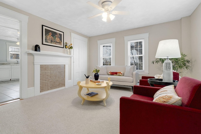 carpeted living room with ceiling fan