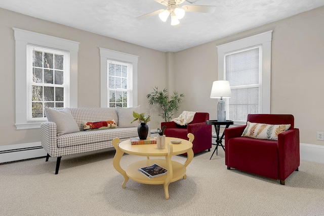 living room featuring a textured ceiling, baseboard heating, ceiling fan, and carpet floors