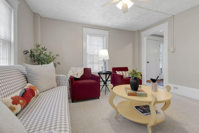 carpeted living room with ceiling fan and a textured ceiling