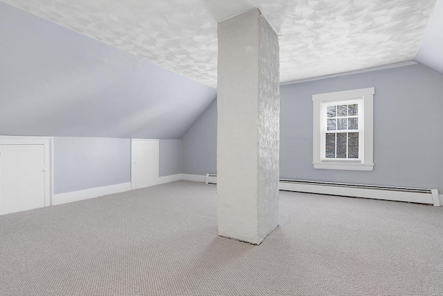 bonus room featuring a textured ceiling, a baseboard radiator, light carpet, and vaulted ceiling