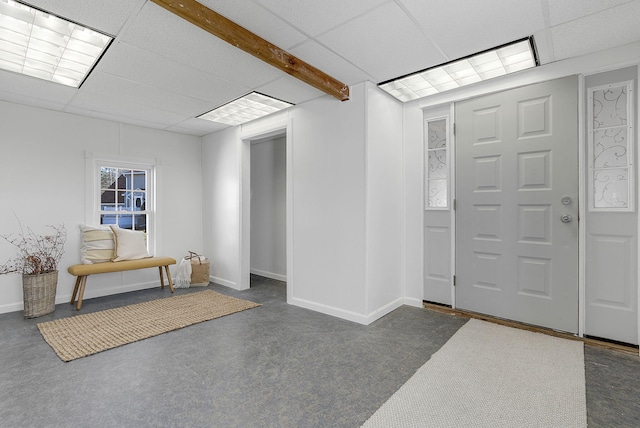 carpeted entryway with a drop ceiling