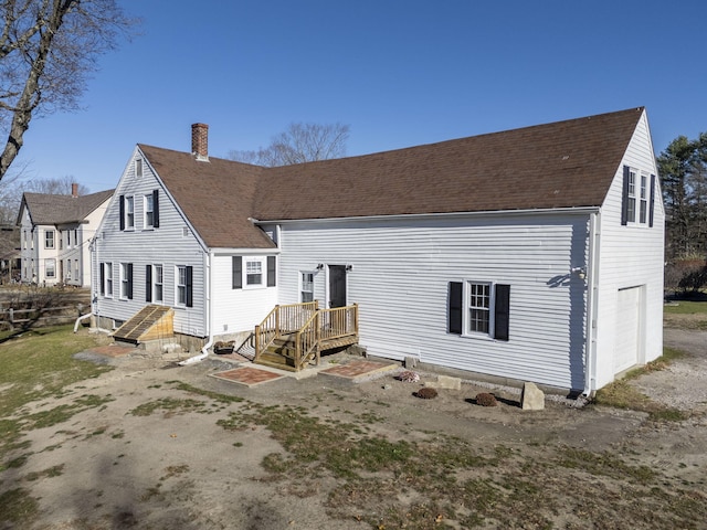 rear view of property featuring a garage