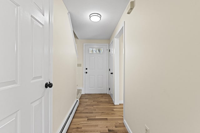 hall featuring baseboard heating and light wood-type flooring