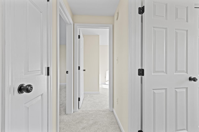 hallway with light colored carpet