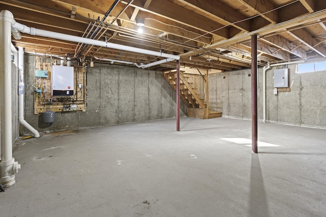 basement with electric panel and tankless water heater