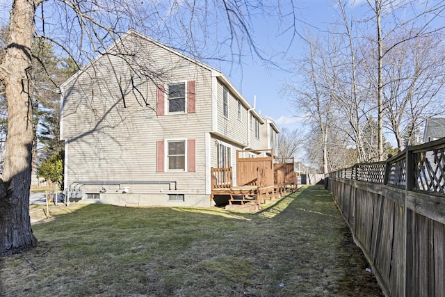 exterior space featuring a lawn and a deck