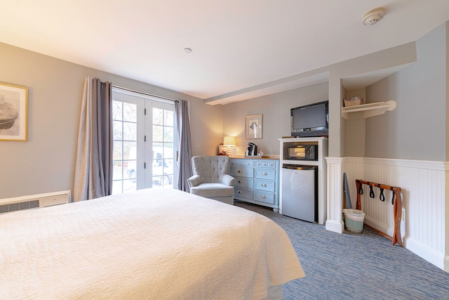 bedroom with stainless steel refrigerator and carpet flooring