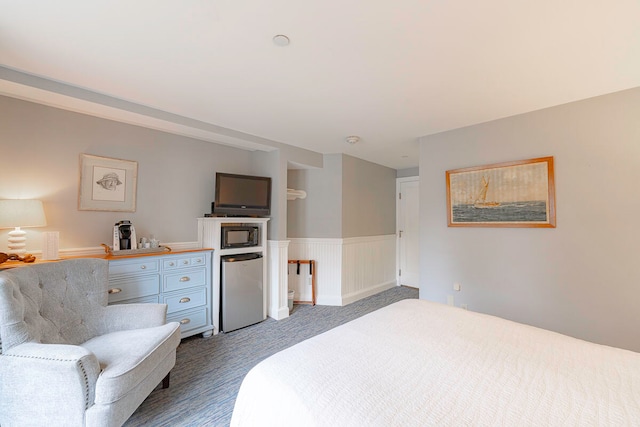 bedroom with stainless steel refrigerator and carpet